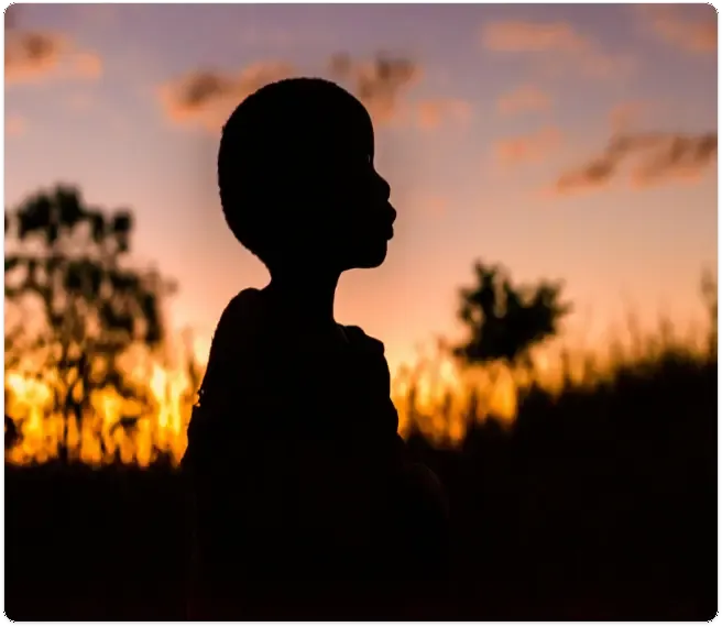 Child profile silhouette at sunset